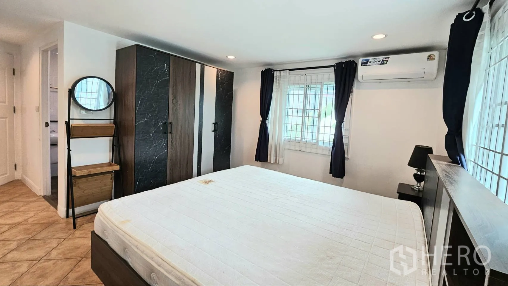 Detached House for rent in Saphan Sung, Bangkok - Master bedroom with large bed, two-tone wardrobes, bedside tables, and air conditioning.