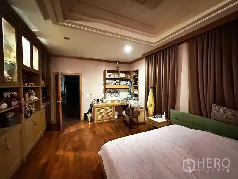 Detached House for sale in Bang Khun Thian, Bangkok - Master bedroom with built-in cabinetry, dressing area and wood floors.