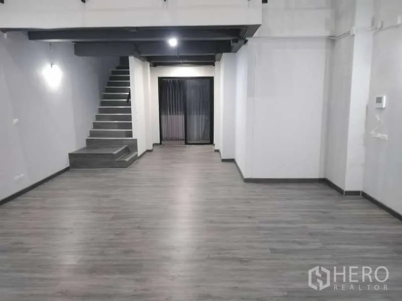 Home Office for rent or sale - Spacious ground-floor open plan area with staircase, grey vinyl floors and rear sliding door.