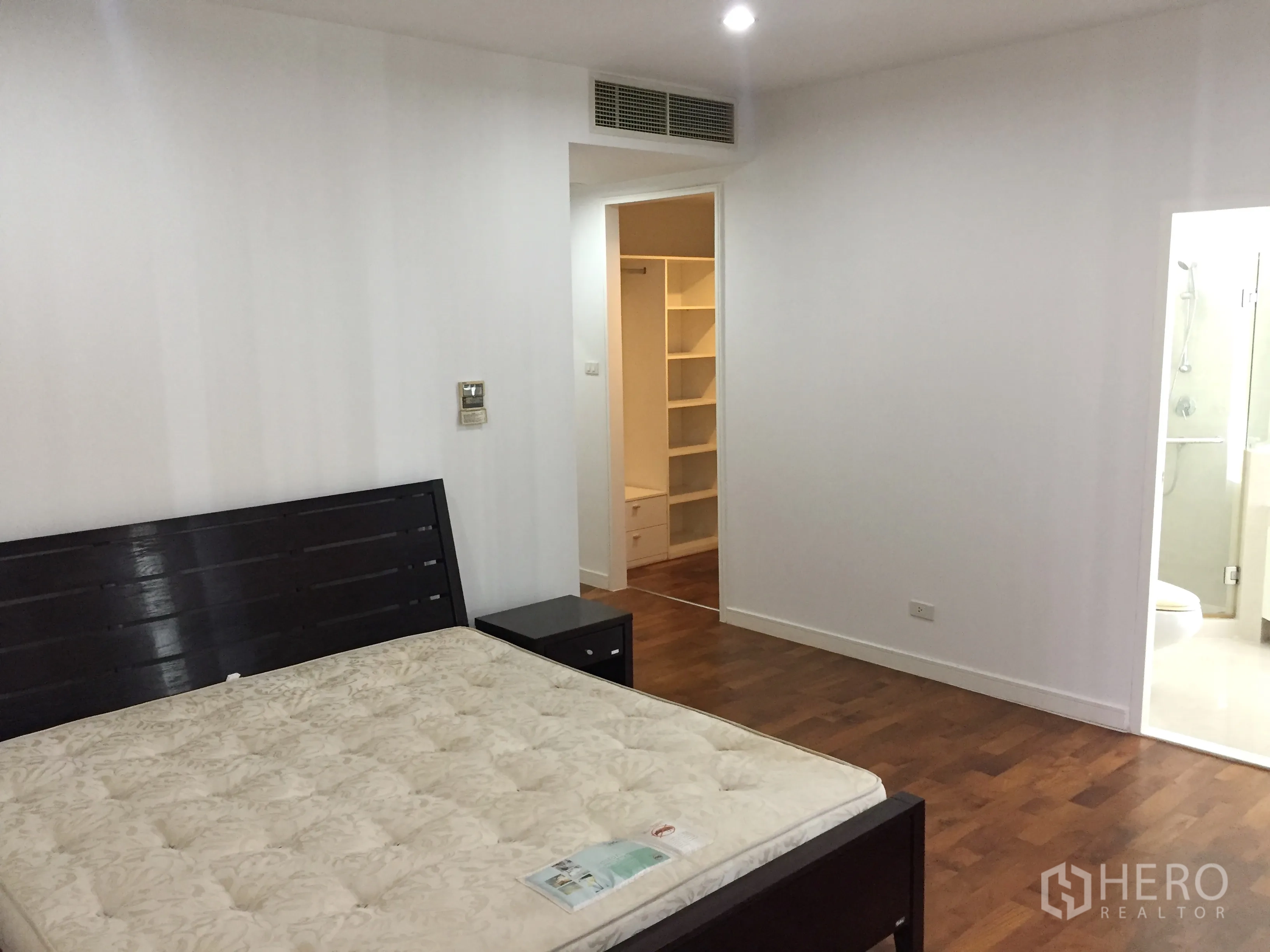 公寓 出租在Khlong Toei, Bangkok - 主卧带木地板，通往步入式衣帽间与套内卫浴。