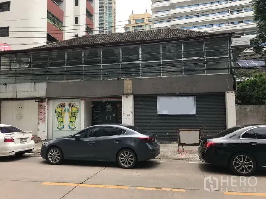 พื้นที่ขายปลีก ให้เช่าในWatthana, Bangkok - อาคารพาณิชย์สองชั้นด้านหน้าแบบโรลเลอร์ชัตเตอร์ ประตูกระจก และที่จอดรถหน้าร้านย่านสุขุมวิท