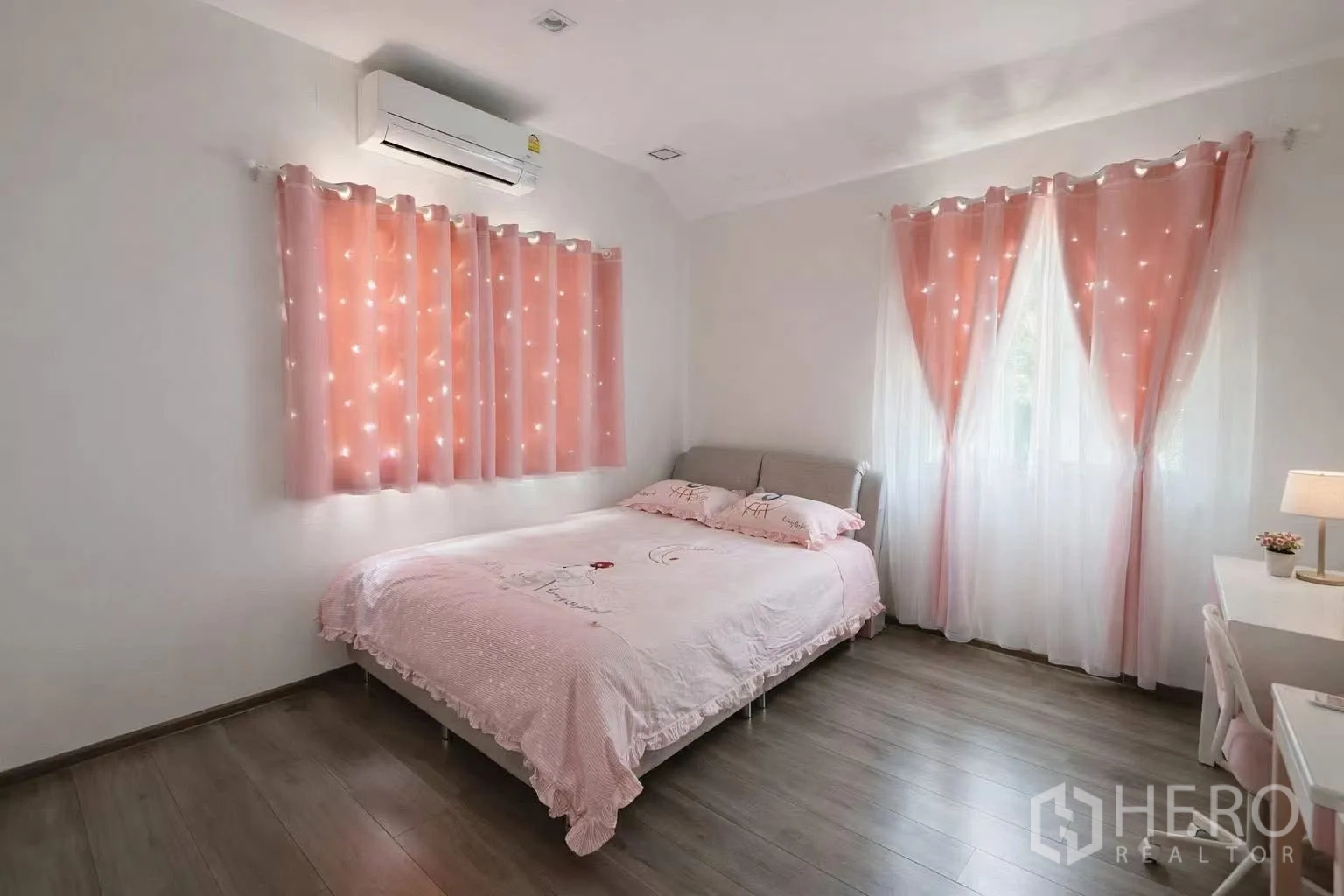 Detached House for rent or sale in Bang Phli, Samut Prakan - Cozy bedroom with pink bedding and twinkling pink curtains.