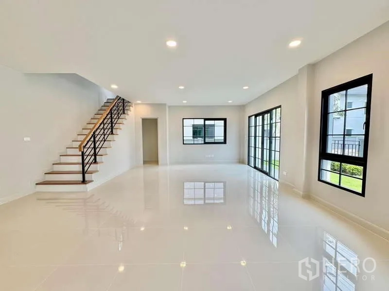 Detached House for sale in Bang Phli, Samut Prakan - Living area view toward the staircase and sliding doors to the garden.