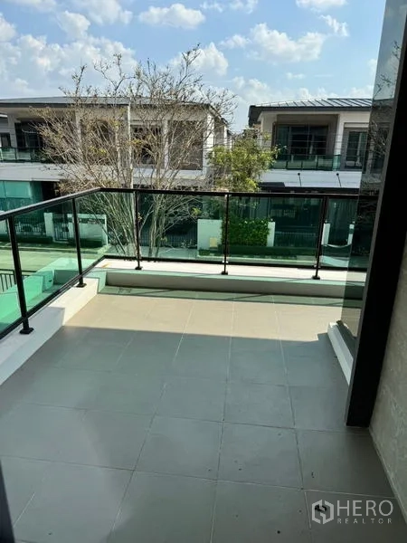 Detached House for rent or sale - Upper-floor balcony with glass railing overlooking a quiet residential street.