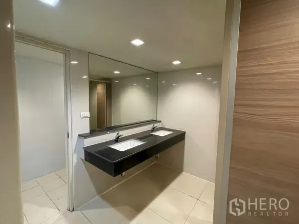 Office Space for rent in Ratchathewi, Bangkok - Modern restroom with double sinks, large mirror and recessed lights.