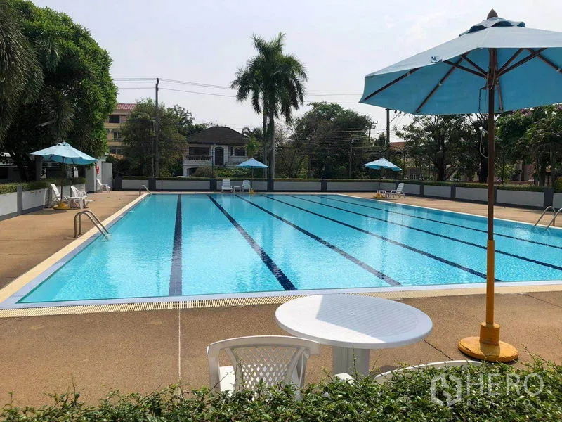 Detached House for rent - Large communal swimming pool with sun umbrellas, tables and deck chairs.