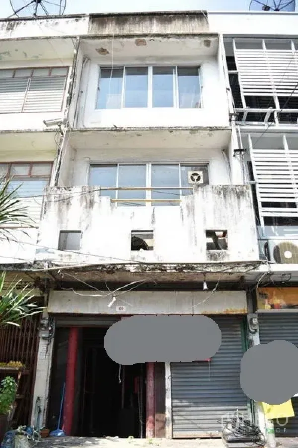 店屋 出租在Khlong Toei, Bangkok - 四层店屋外立面，带阳台与卷帘门，老旧立面