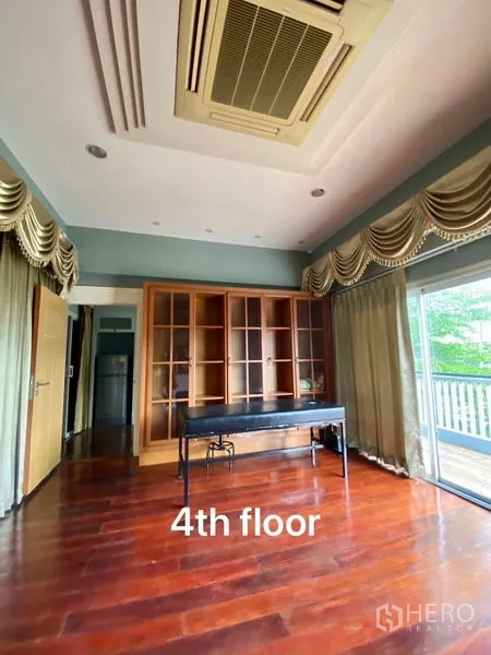 Home Office for rent or sale in Suan Luang, Bangkok - Fourth‑floor office room with built‑in bookshelf, wood floors and balcony access.