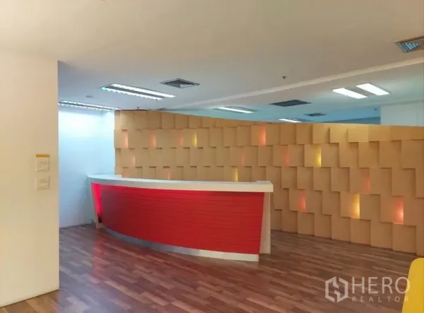 办公空间 出租在Chatuchak, Bangkok - 前台区域，红色柜台搭配纹理墙面，风格现代。