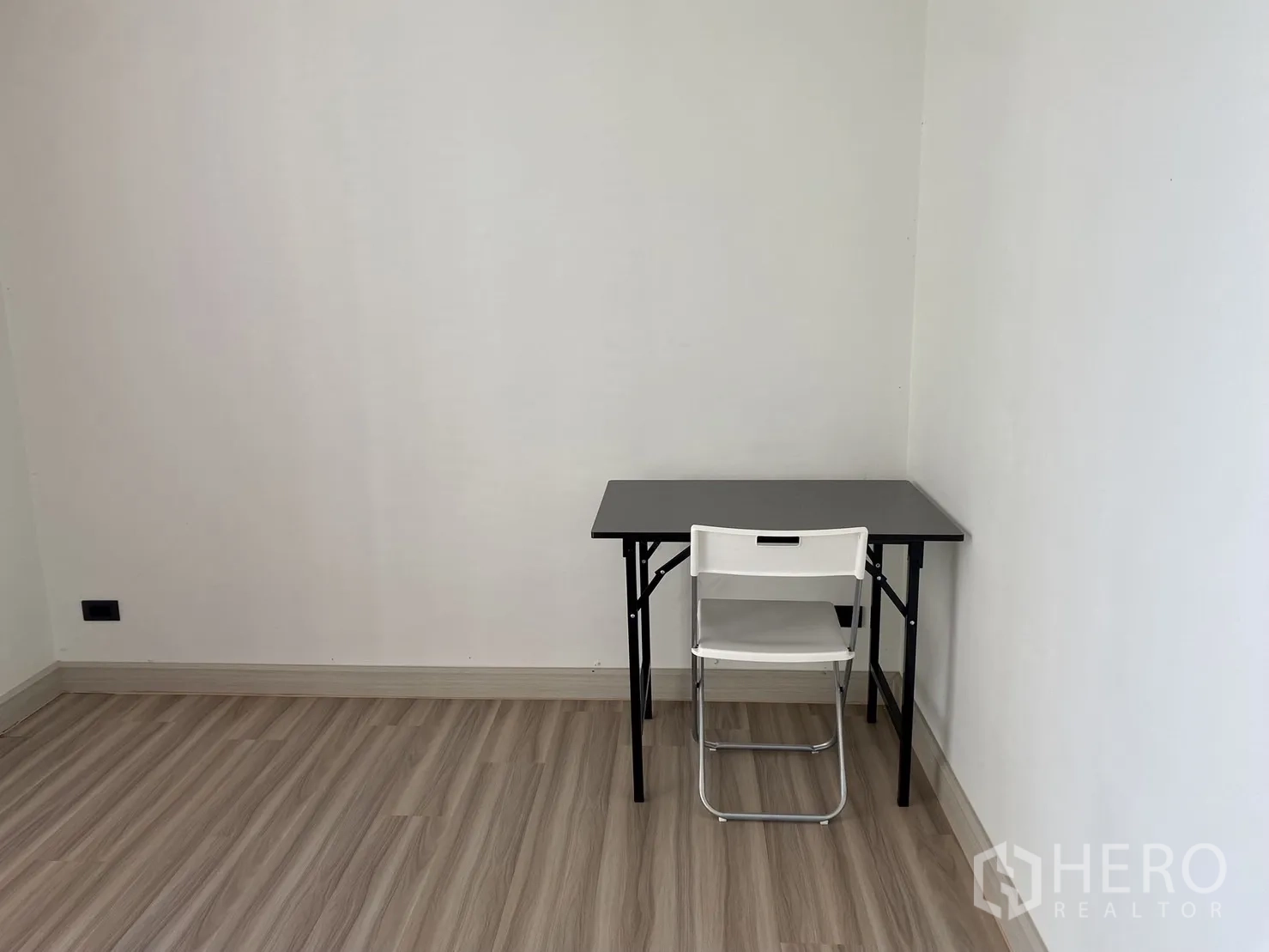 Home Office for rent or sale in Phra Khanong, Bangkok - Compact study nook with folding table and chair, wood floors.
