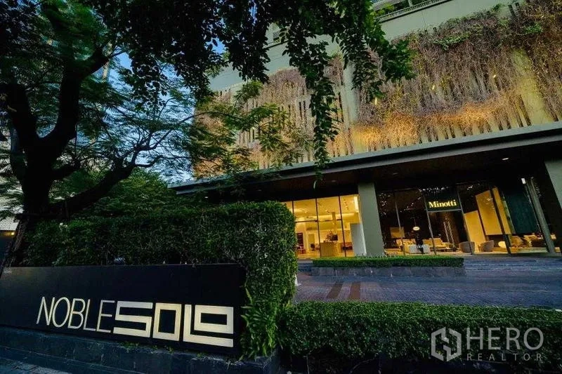 Condominium for rent in Watthana, Bangkok - Exterior facade with illuminated lobby and Noble Solo signage.