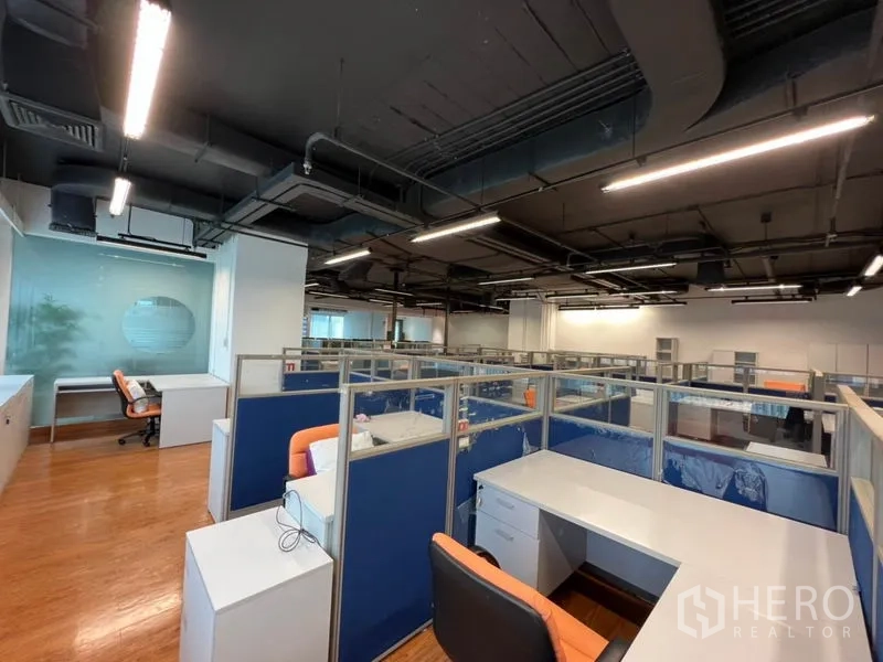 Office Space for rent in Khlong Toei, Bangkok - Rows of workstations beneath exposed ducting and linear lighting.