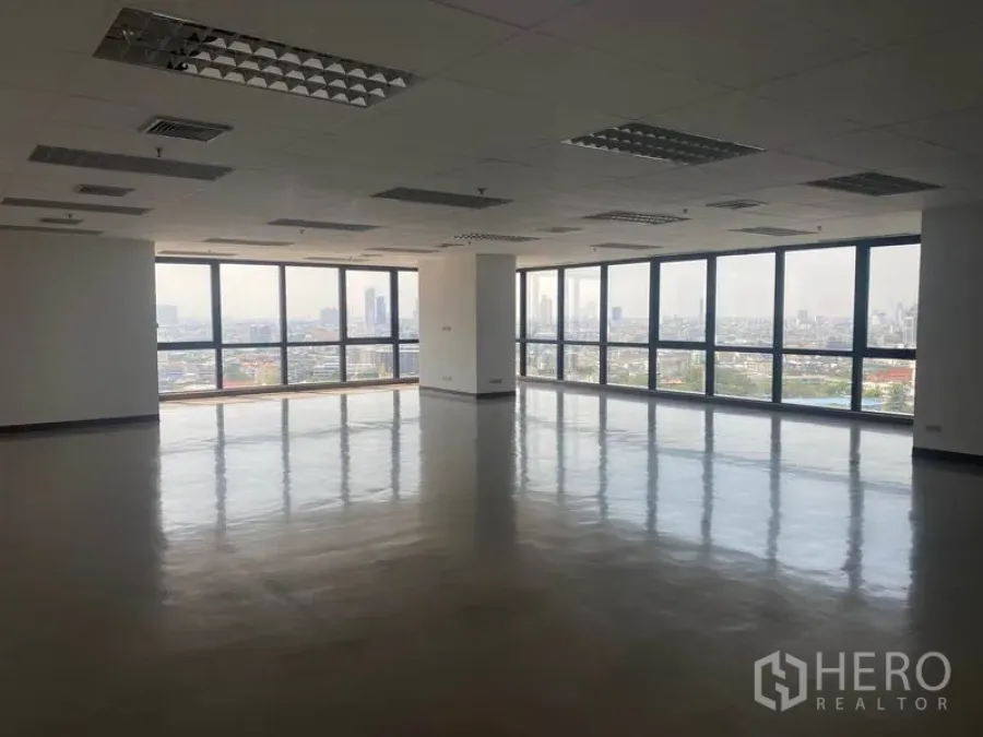 Office Space for rent in Sathon, Bangkok - Spacious open-plan office with polished floors, grid ceiling lights and large corner windows offering panoramic Bangkok skyline views.
