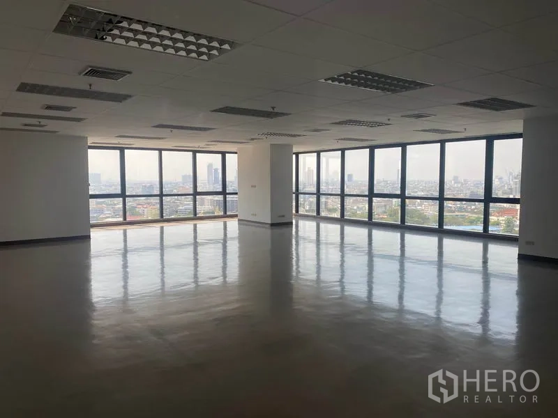 Office Space for rent in Sathon, Bangkok - Spacious open-plan office with polished floors, grid ceiling lights and large corner windows offering panoramic Bangkok skyline views.