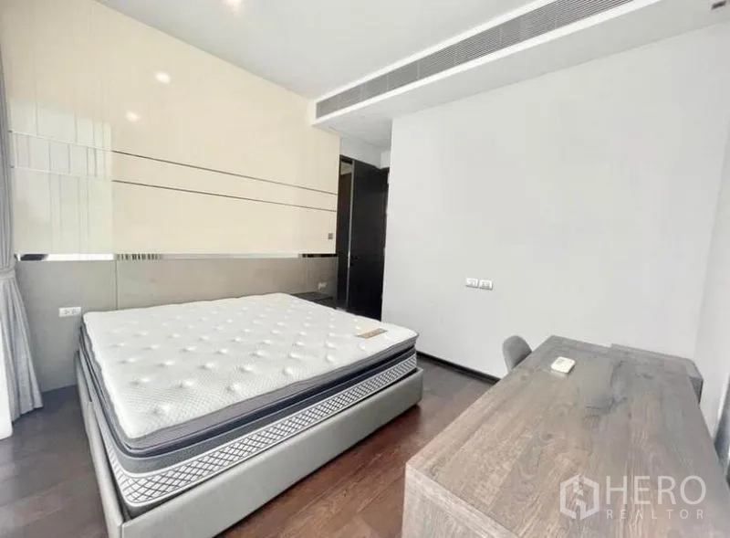 Condominium for rent in Watthana, Bangkok - Bedroom with upholstered bed, glossy headboard and work desk.