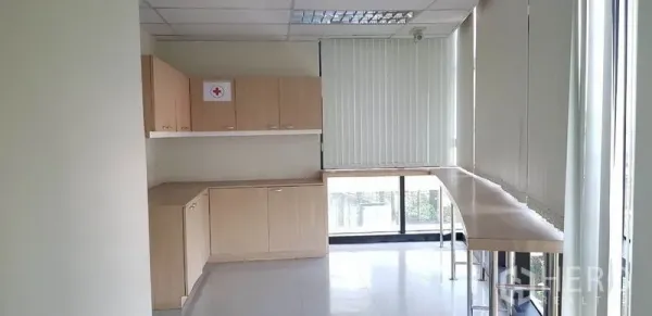 办公空间 出租在Khlong Toei, Bangkok - 紧凑茶水间/储物区，浅木色柜体与沿窗长台面，配百叶。