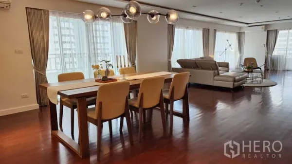 公寓 出租在Sathon, Bangkok - 开放式客餐厅，环窗采光，球形吊灯与皮沙发。