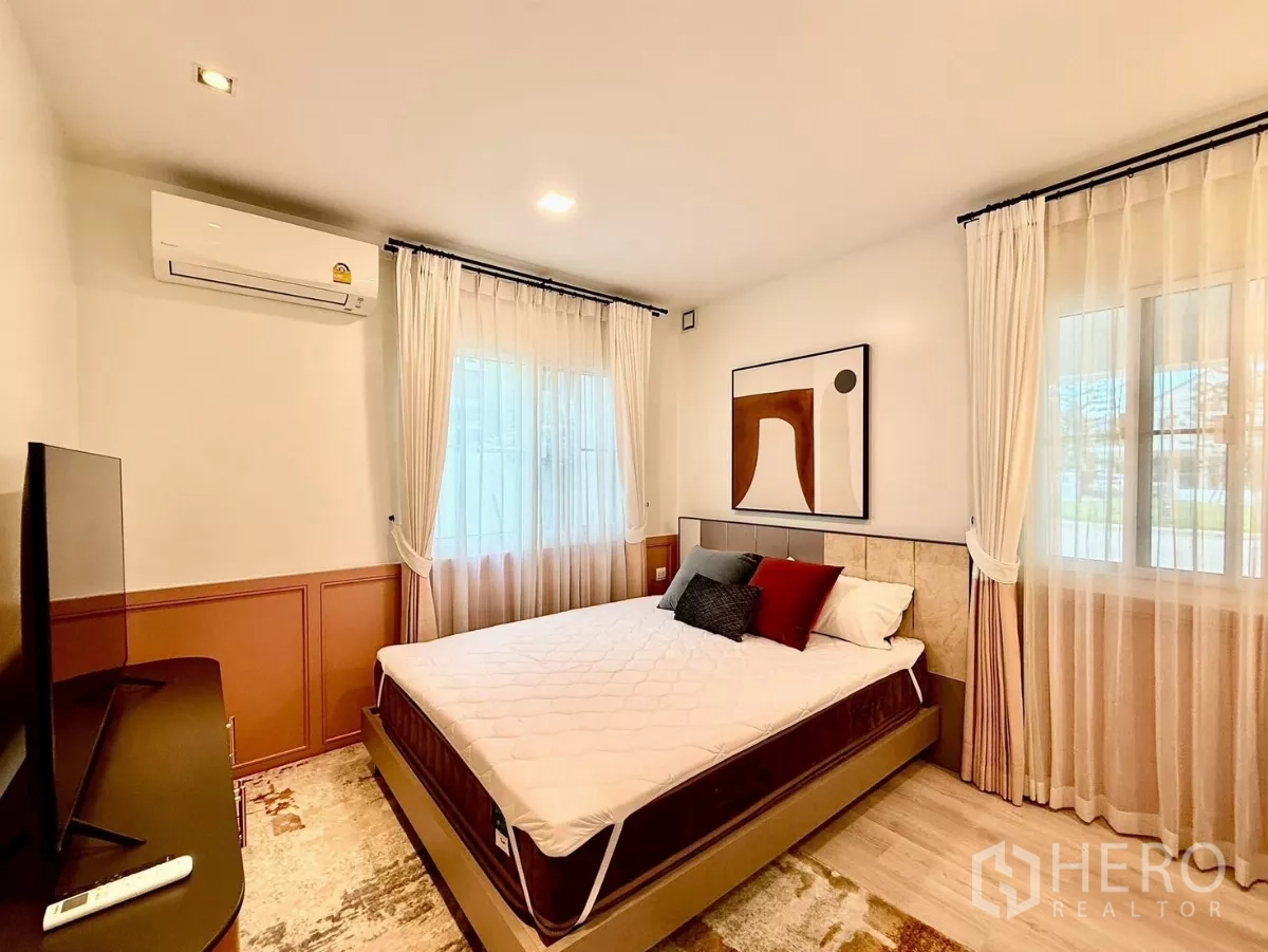 Detached House for rent in Bang Phli, Samut Prakan - Guest bedroom with double bed, artwork and large windows.