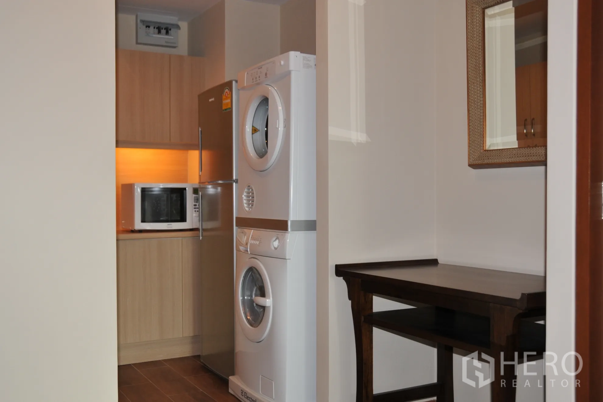 公寓 出租在Khlong Toei, Bangkok - 紧凑厨房，冰箱、微波炉与叠放式洗烘设备。