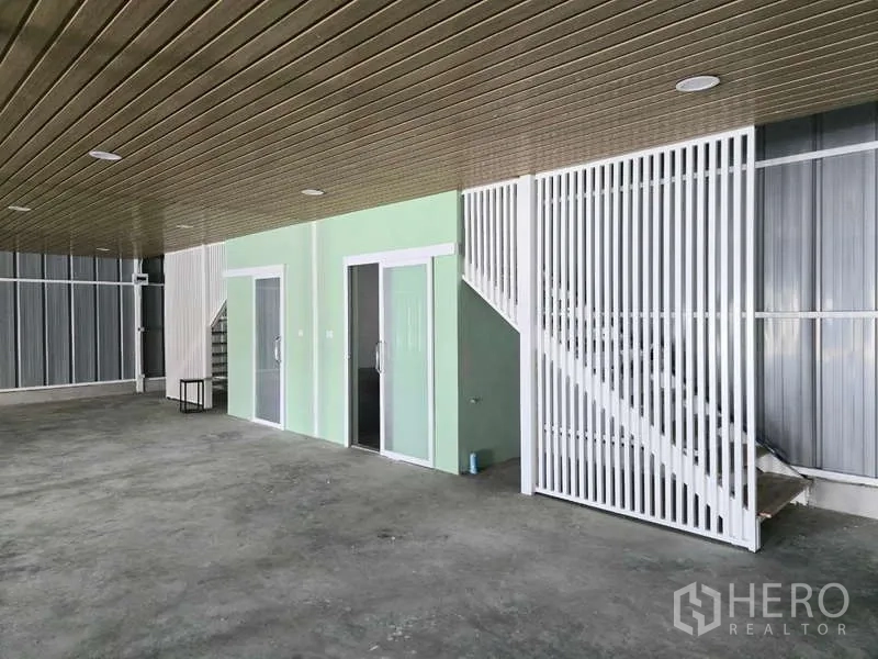 Warehouse for rent in Wang Thonglang, Bangkok - Ground-floor office rooms with glass doors and an internal staircase to the mezzanine.
