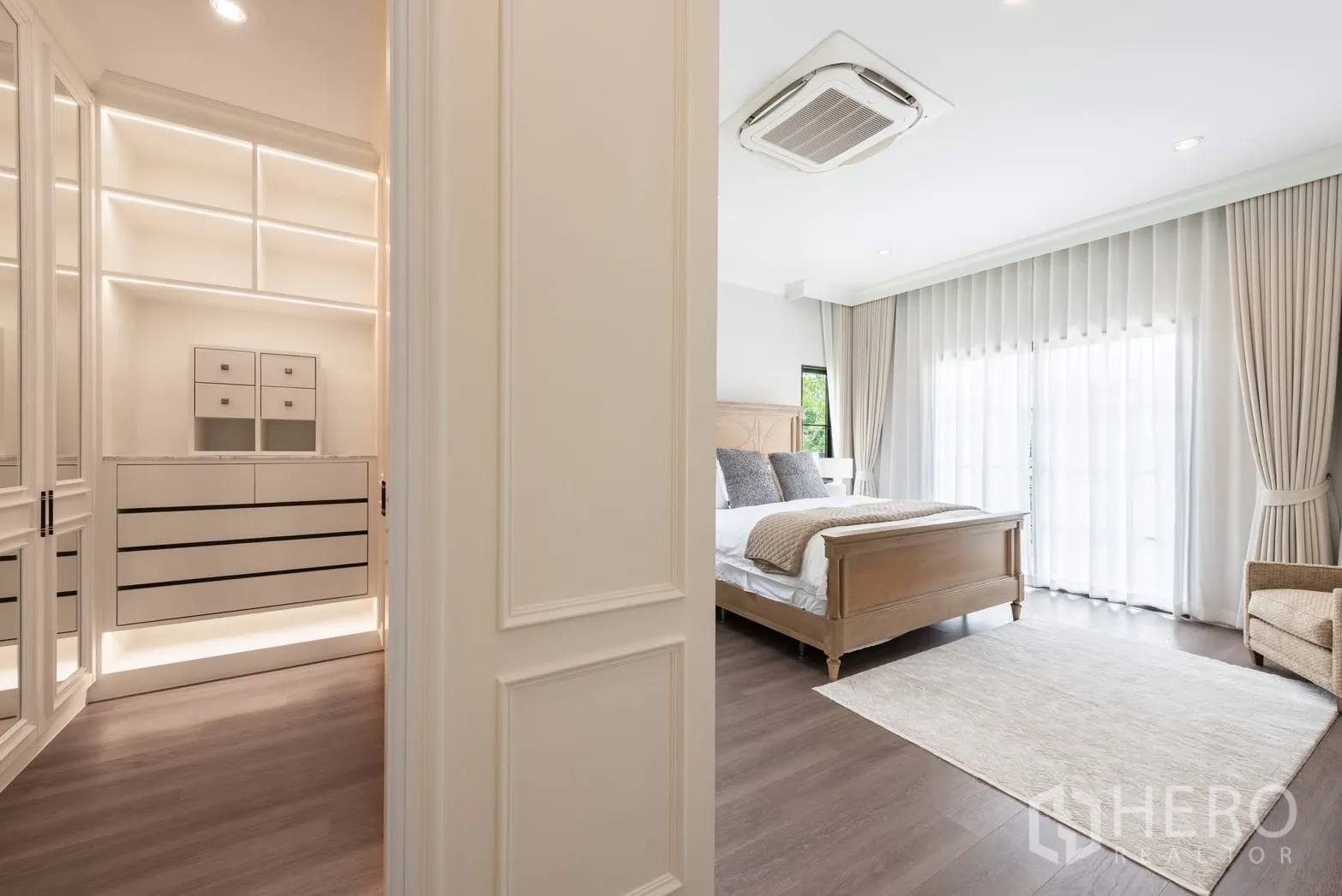 Detached House for rent or sale in Bang Phli, Samut Prakan - Transition from walk-in closet to a bright bedroom with wooden bed.