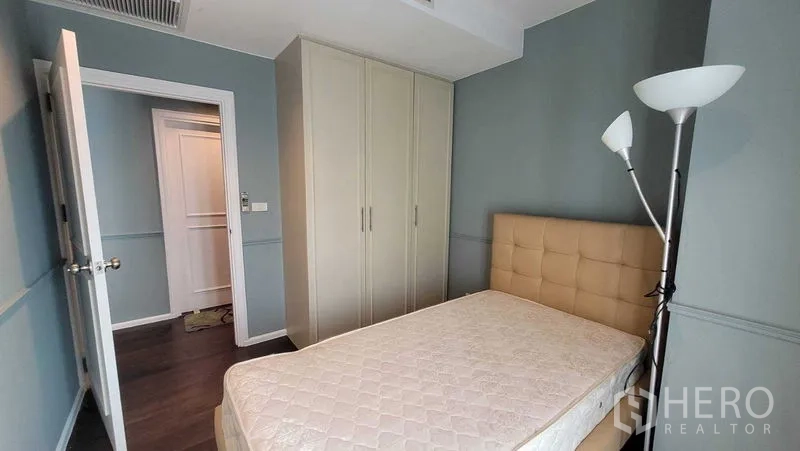 คอนโด ให้เช่าในKhlong Toei, Bangkok - ห้องนอนพร้อมตู้เสื้อผ้าบิวท์อิน หัวเตียงบุ และโคมไฟยืน ผนังโทนฟ้า