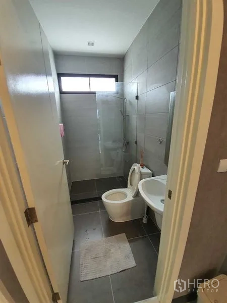 Detached House for sale in Bang Khun Thian, Bangkok - Modern bathroom with gray tiles, glass-enclosed shower, toilet and basin.