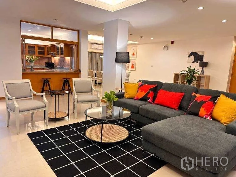 Apartment for rent - Evening view of the living room with sectional sofa and colorful cushions.