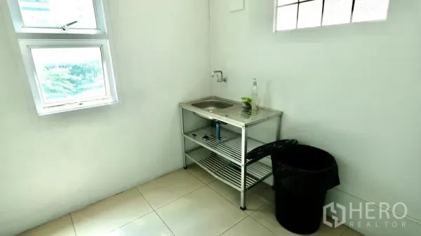 Office Space for rent in Bang Rak, Bangkok - Compact office pantry with stainless sink, window and tiled floor.