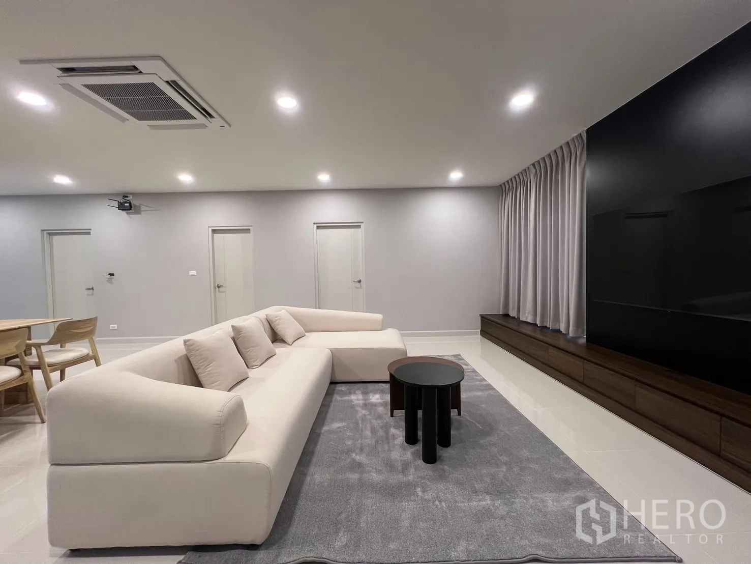 Detached House for rent in Bang Phli, Samut Prakan - Living area with sleek media wall, long TV console and full-length curtains.