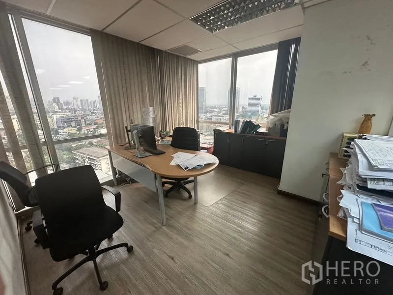 Office Space for rent - Corner private office with city views through floor-to-ceiling windows