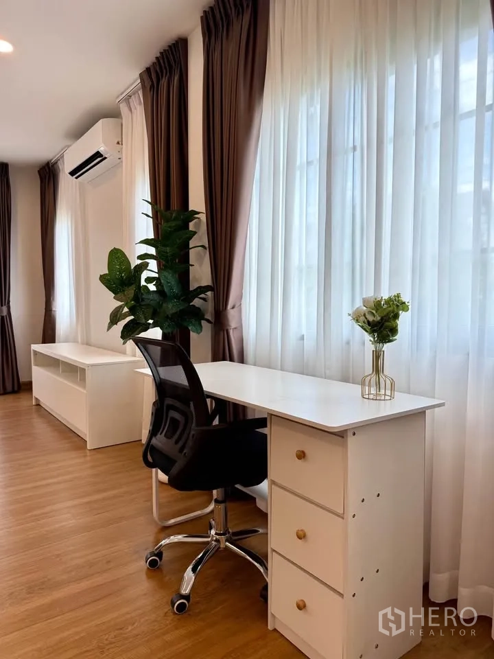 Detached House for rent in Bang Phli, Samut Prakan - Light-filled study corner with white desk, chair, and plants by windows.