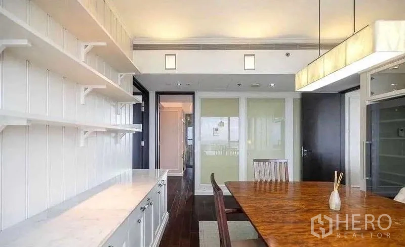 Condominium for rent - Bright dining area with built-in white shelves and wooden table.