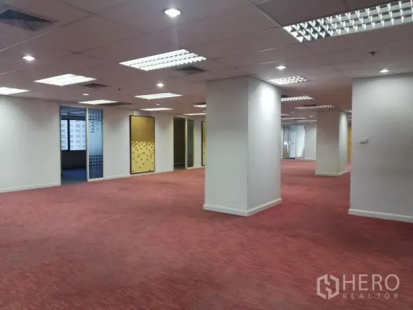 Office Space for rent in Watthana, Bangkok - Spacious open-plan office floor with red carpet, structural columns and grid ceiling lighting.