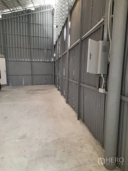 คลังสินค้า ให้เช่าในSathon, Bangkok - ทางเดินข้างโกดัง แสดงตู้ไฟและท่อเดินสายบนผนังเมทัลชีท