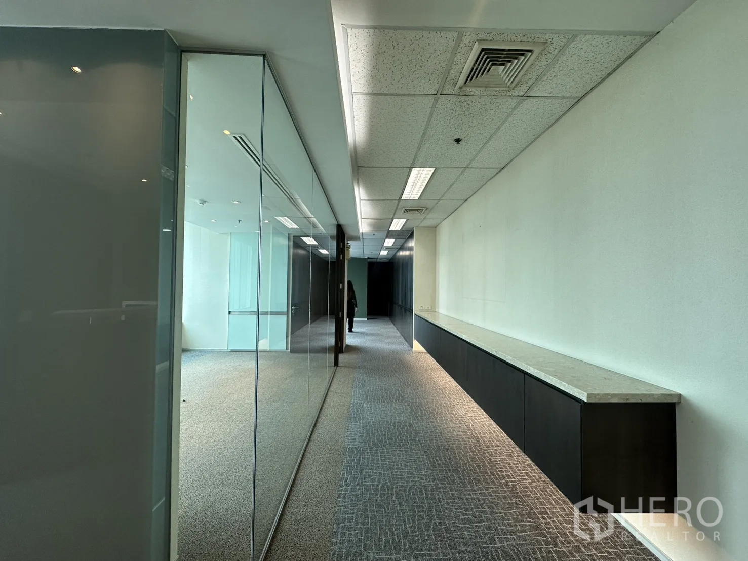 ออฟฟิศ for rent in Watthana, Bangkok - โถงทางเดินปูพรม ผนังกระจก และตู้บิวท์อินยาวพร้อมไฟส่องใต้