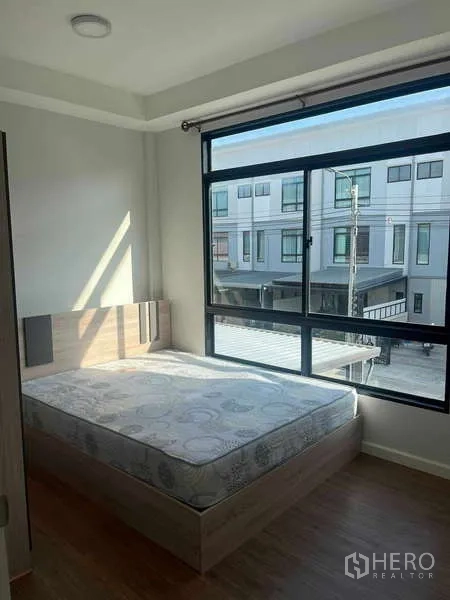 ทาวน์เฮาส์ ให้เช่าในSuan Luang, Bangkok - ห้องนอนเตียงควีนพร้อมหน้าต่างกว้างมองเห็นถนนหน้าทาวน์โฮม