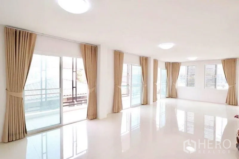 Home Office for rent in Bang Sue, Bangkok - Spacious top-floor multipurpose area with multiple sliding doors, beige curtains and terrace access.