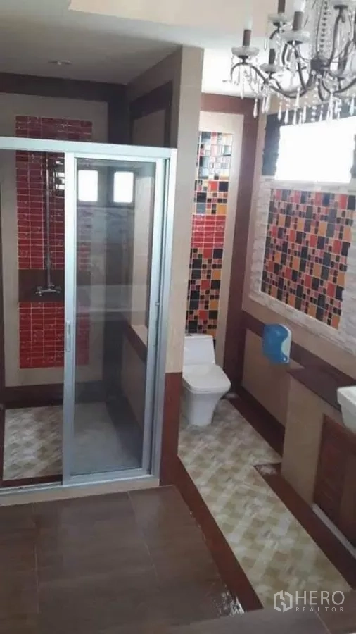 Detached House for sale in Bueng Kum, Bangkok - Bathroom with glass shower enclosure and colorful tile accents.
