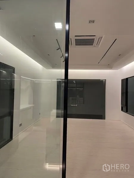 Detached House for sale in Saphan Sung, Bangkok - Sleek corridor with a glass partition and recessed LED lighting.