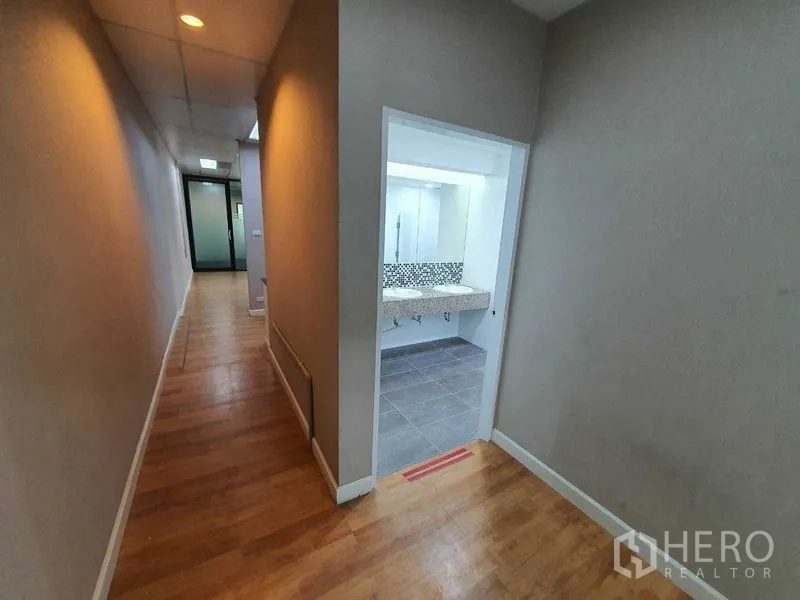 สำนักงาน ให้เช่าในDin Daeng, Bangkok - ทางเดินพื้นไม้เชื่อมห้องน้ำสว่าง พร้อมผนังกระเบื้องโมเสก