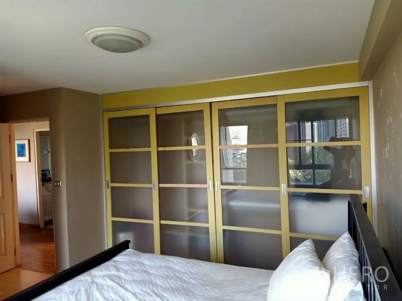 คอนโด ให้เช่าในKhlong Toei, Bangkok - ห้องนอนใหญ่มีตู้เสื้อผ้าบานเลื่อนกระจกฝ้าและหน้าต่างมองเห็นวิวเมือง