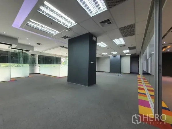 Office Space for rent in Watthana, Bangkok - Open-plan office with suspended grid ceiling lights and glass-walled rooms.