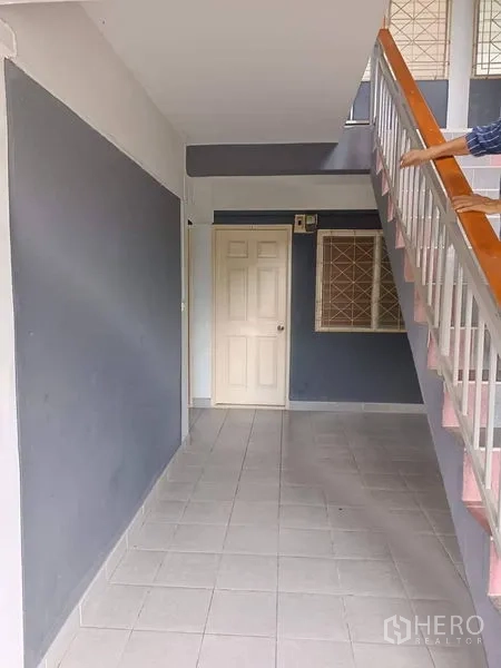 Retail Space for sale in Lam Luk Ka, Pathum Thani - Tiled ground-floor corridor with white door and stair railings.