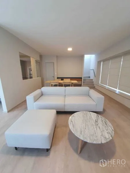 Townhouse for rent - Spacious living and dining area with staircase to the upper floor.