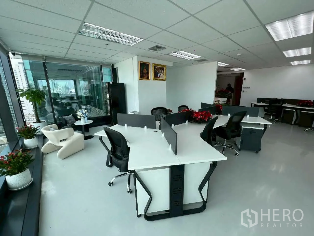 Office Space for rent in Din Daeng, Bangkok - Corner lounge beside a glass-partitioned executive office with potted plants.