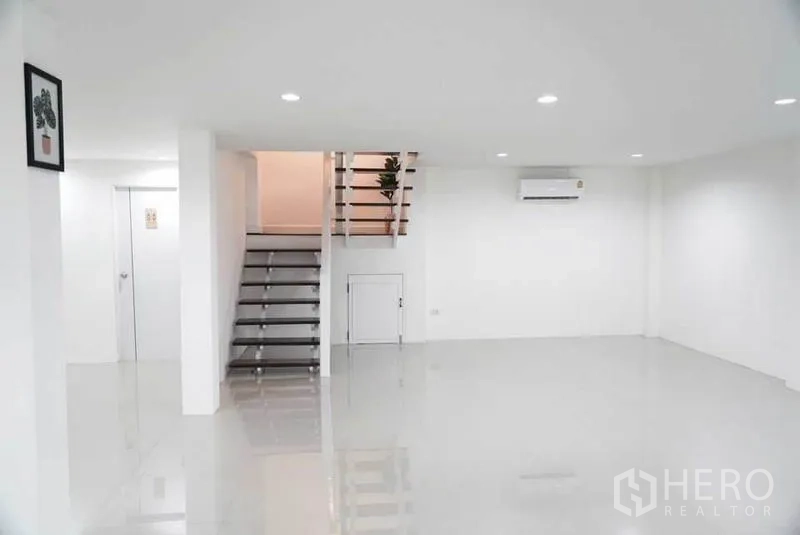 Detached House for sale in Bang Bon, Bangkok - Large living room with split air conditioner, downlights and stairs leading to the upper floor.