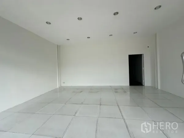 Office Space for rent in Khlong Toei, Bangkok - Bright open‑plan office with white tiled floor, recessed lights and plain walls ready for fit‑out.