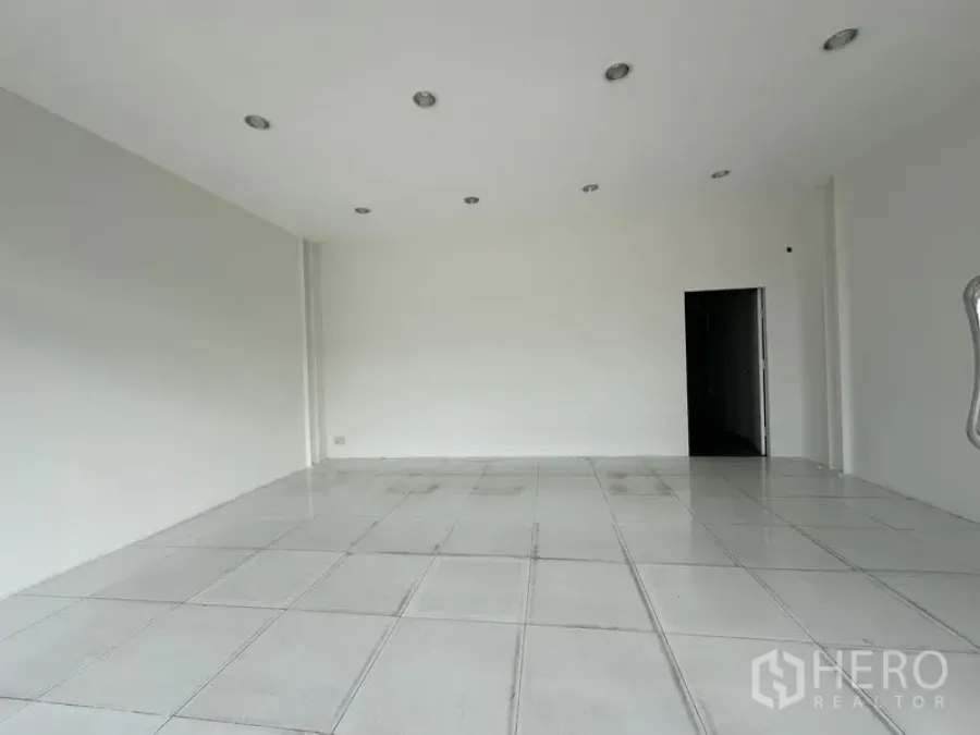 Office Space for rent in Khlong Toei, Bangkok - Bright open‑plan office with white tiled floor, recessed lights and plain walls ready for fit‑out.