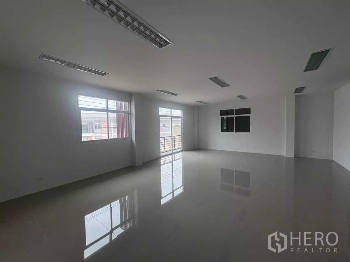 Factory for rent in Phra Samut Chedi, Samut Prakan - Bright upstairs office with windows, balcony access and tiled flooring.